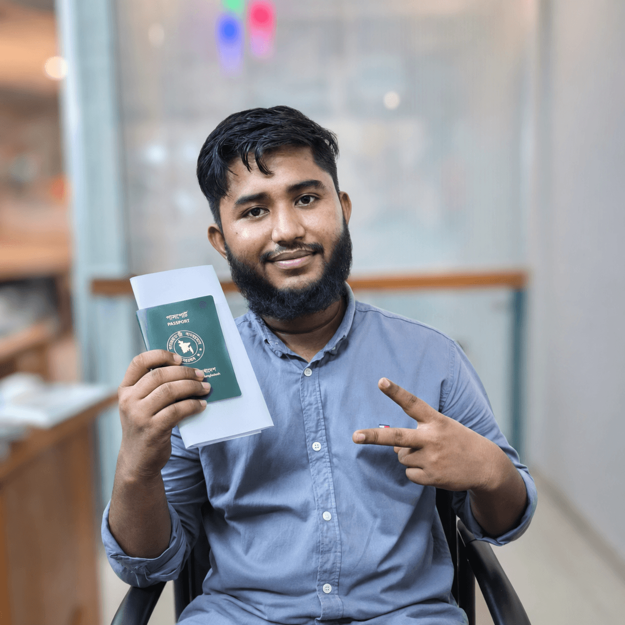 CV Felow client holding an approved passport and letter in the office
